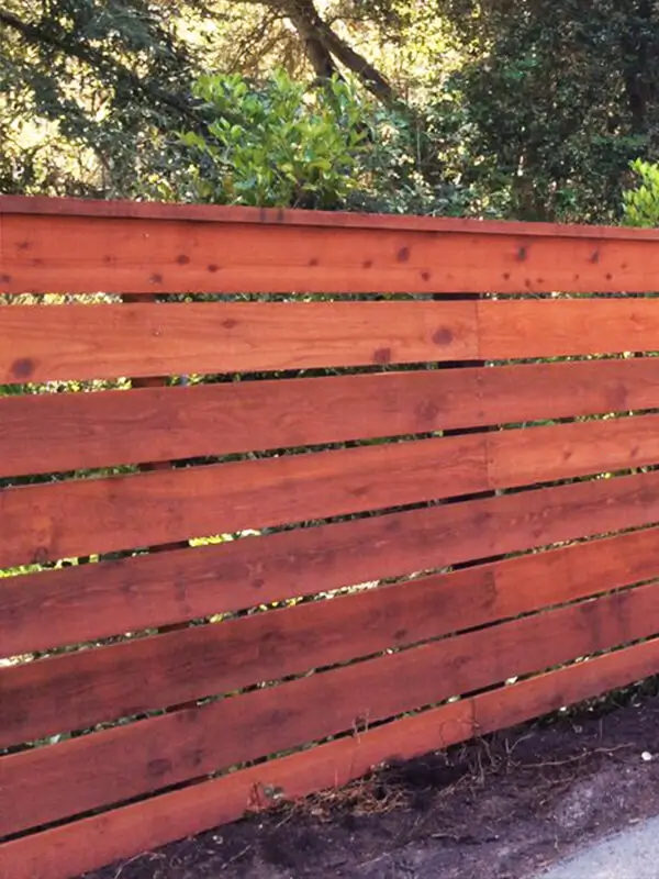 Horizontal spaced picket redwood fence