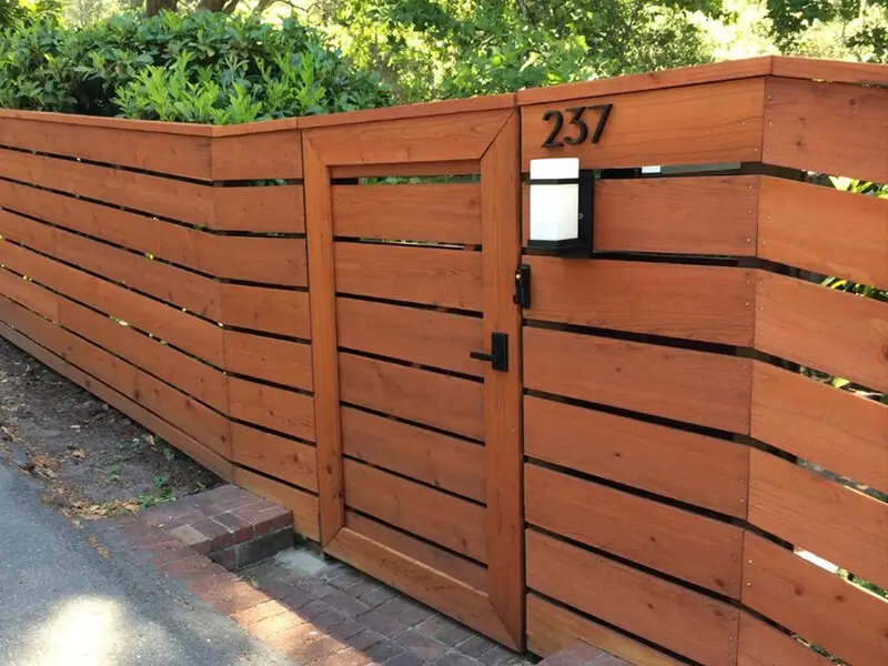 Residential horizontal spaced picket redwood fence