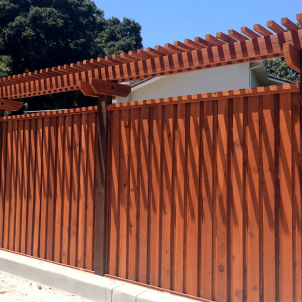 Fence made from redwood lumber with an arbor